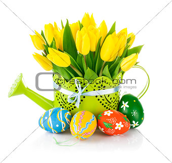 Easter eggs with spring flowers in watering can