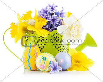 Easter eggs with spring flowers in watering can
