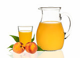 peach juice in a glass and carafe