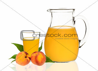 peach juice in a glass and carafe