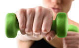 Close up shot of hand by training woman with green dumbbell