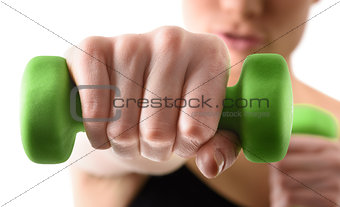 Close up shot of hand by training woman with green dumbbell
