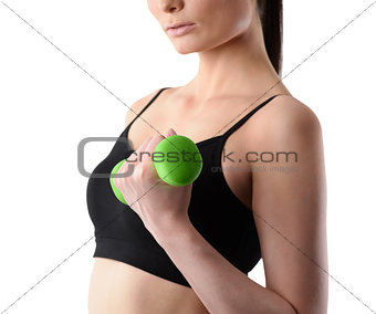 Close up shot without face of fitness woman working out with dumbbell