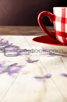 Detail of coffee cup laid on wooden vintage table