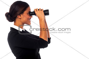 Corporate woman viewing through binoculars
