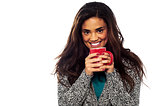 Relaxed mixed race woman having coffee