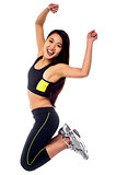 Woman in sportswear jumping with joy