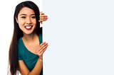 Asian girl holding blank white ad board