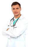 Handsome young doctor posing with crossed arms