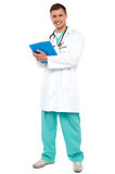 Portrait of smiling doctor holding clipboard