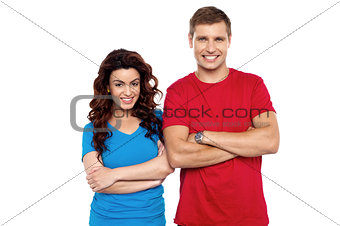 Attractive couple posing with arms crossed