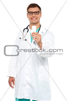 Smiling doctor showing tablets pack to camera