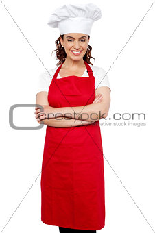 Female chef standing with her arms crossed