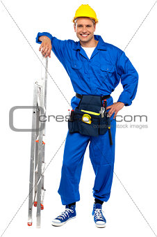 Industrial contractor resting hand on stepladder