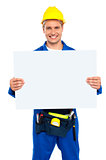 Construction worker holding blank billboard