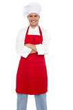 Confident cheerful male chef with arms crossed
