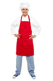 Relaxed chef standing with hands on his waist