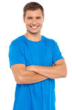 Casual portrait of smiling man posing with arms crossed