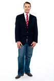 Ful length portrait of young businessman in jeans