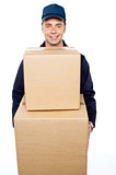 Young man carrying huge cardboard boxes