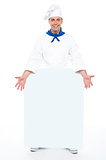 Chef holding blank billboard. Full length shot