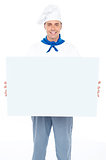 Handsome male chef holding ad board