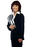 Smiling businesswoman holding her file folder