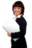Asian corporate female holding laptop