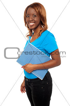 Smiling african college girl carrying her assignment