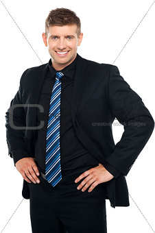 Confident young businessman posing casually