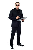 Male bouncer holding clipboard