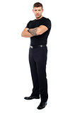 Bouncer with tattoo on hand posing with arms crossed