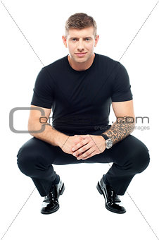 Handsome male bouncer squatting position