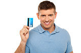 Cheerful man holding credit card