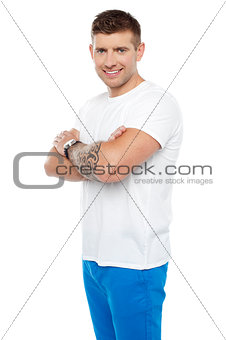 Smart young man posing with crossed arms