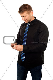 Young businessperson browsing in his cell phone