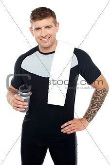 Energetic fit man holding water bottle