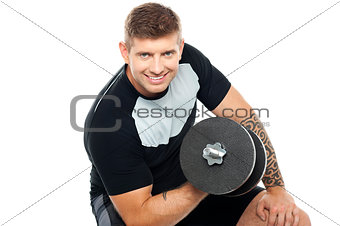 Muscular man working out with barbell