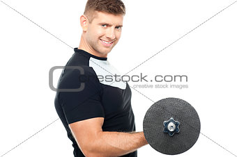 Side pose of gym instructor lifting weights