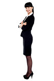 Cheerful confident business lady posing with arms crossed