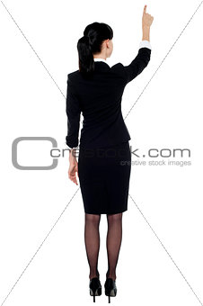 Professional corporate lady pointing at copy space area