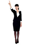 Business lady pointing her finger upwards
