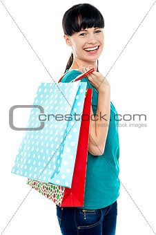 Girl with shopping bags tossed over her shoulders