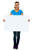 Trendy woman displaying blank billboard
