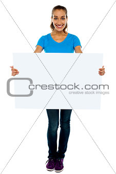 Trendy woman displaying blank billboard