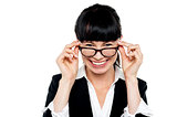 Cheerful woman taking off her spectacles