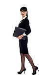Cheerful smart business lady walking with files