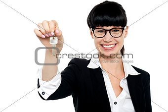 Smiling female executive handing over the key