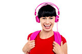 Young girl listening to music, using headphones