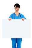 Medical practitioner holding blank ad board
